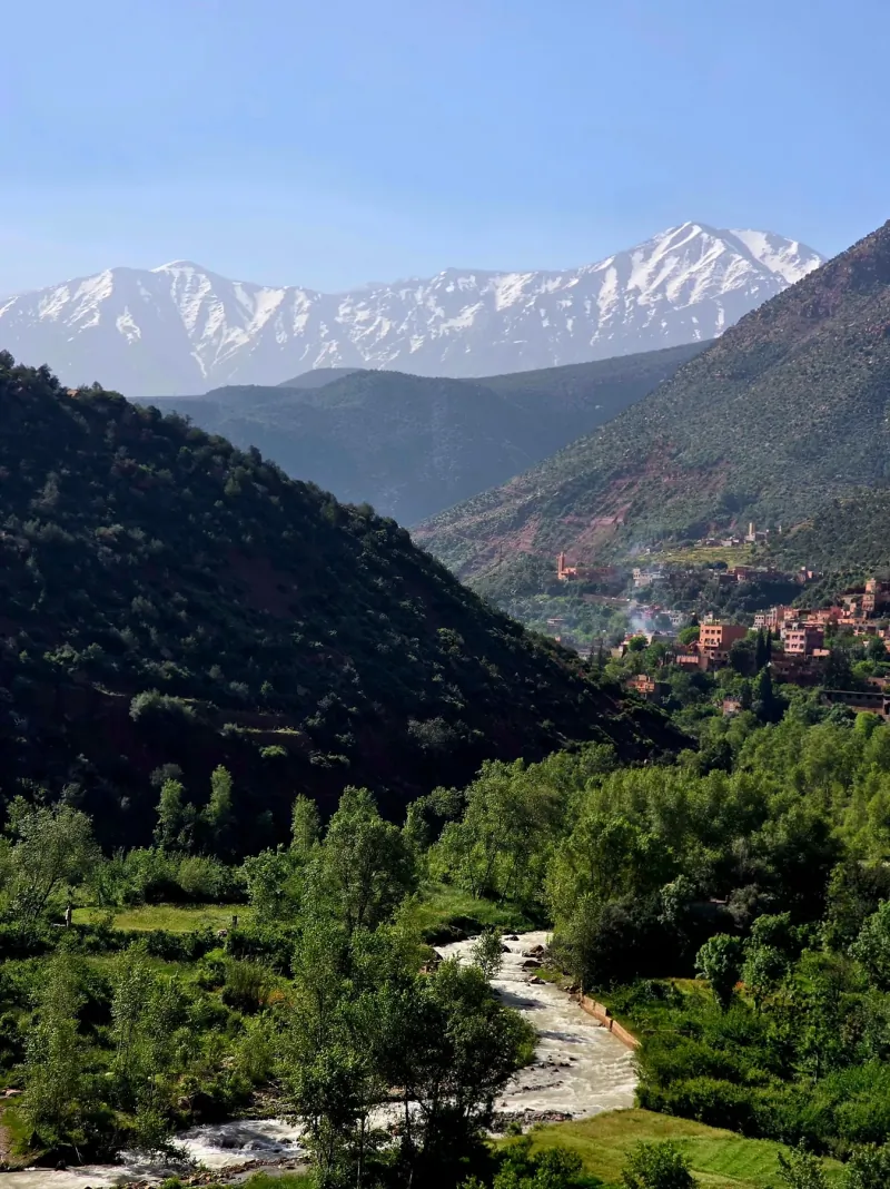 Road winding through the snow-capped High Atlas Mountains