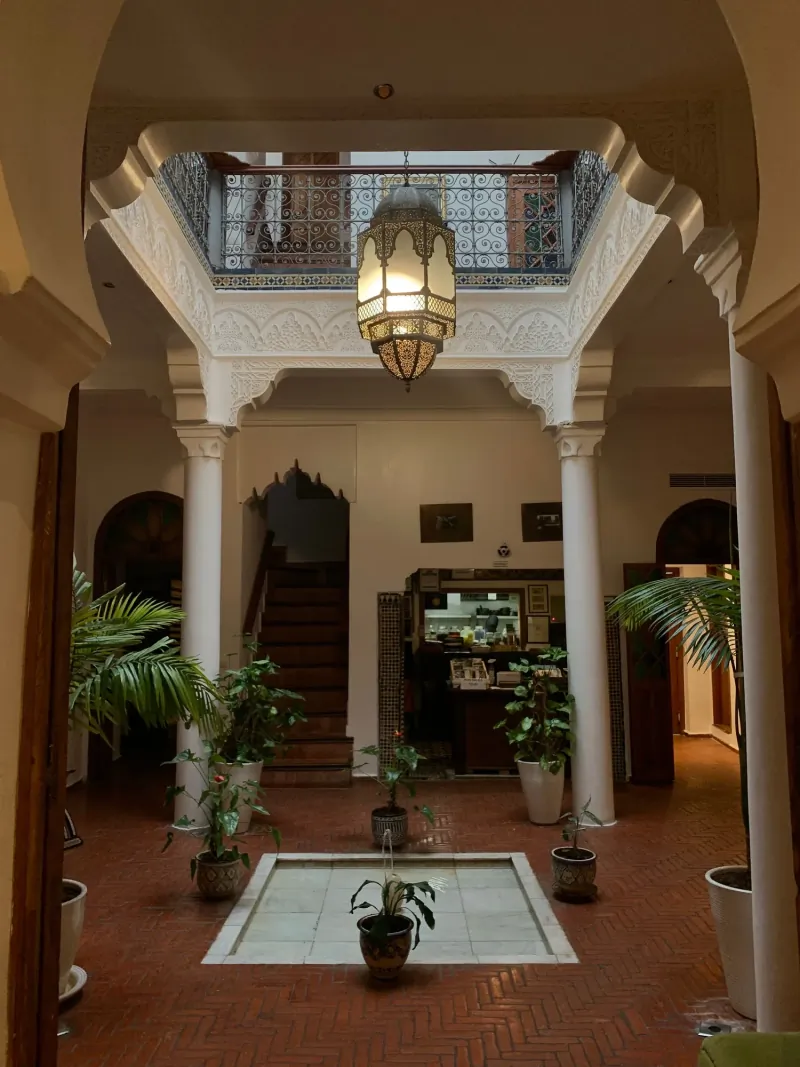 Traditional riad courtyard with a hanging lantern