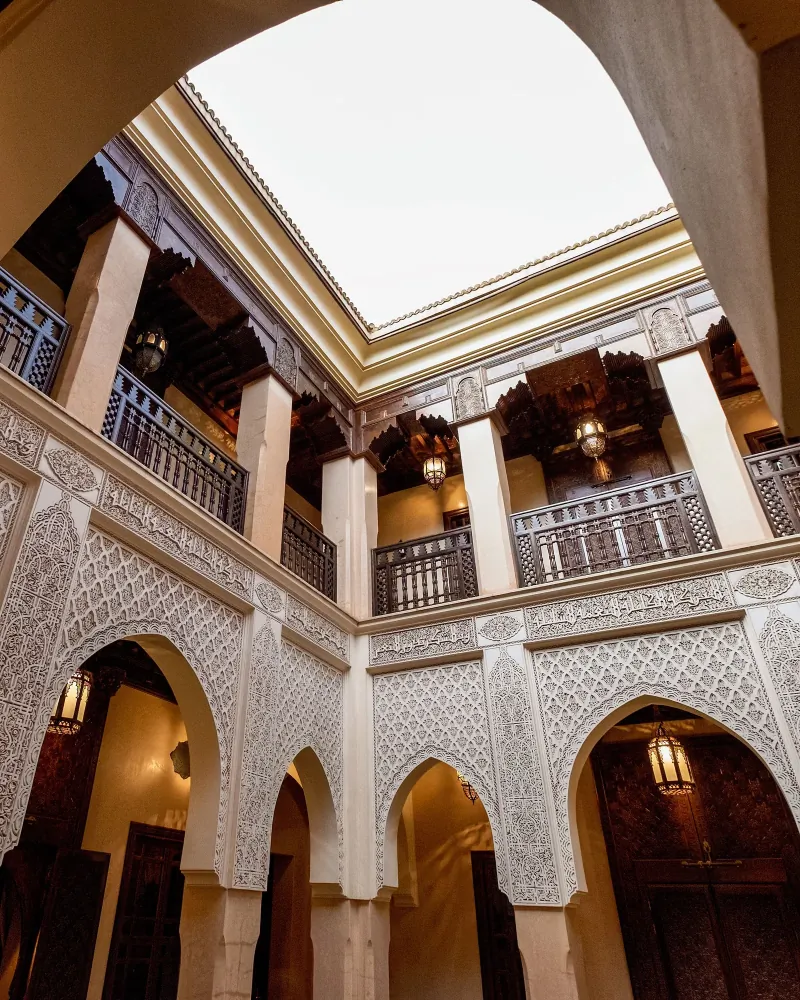 Ornate carved arches in a Moroccan riad courtyard