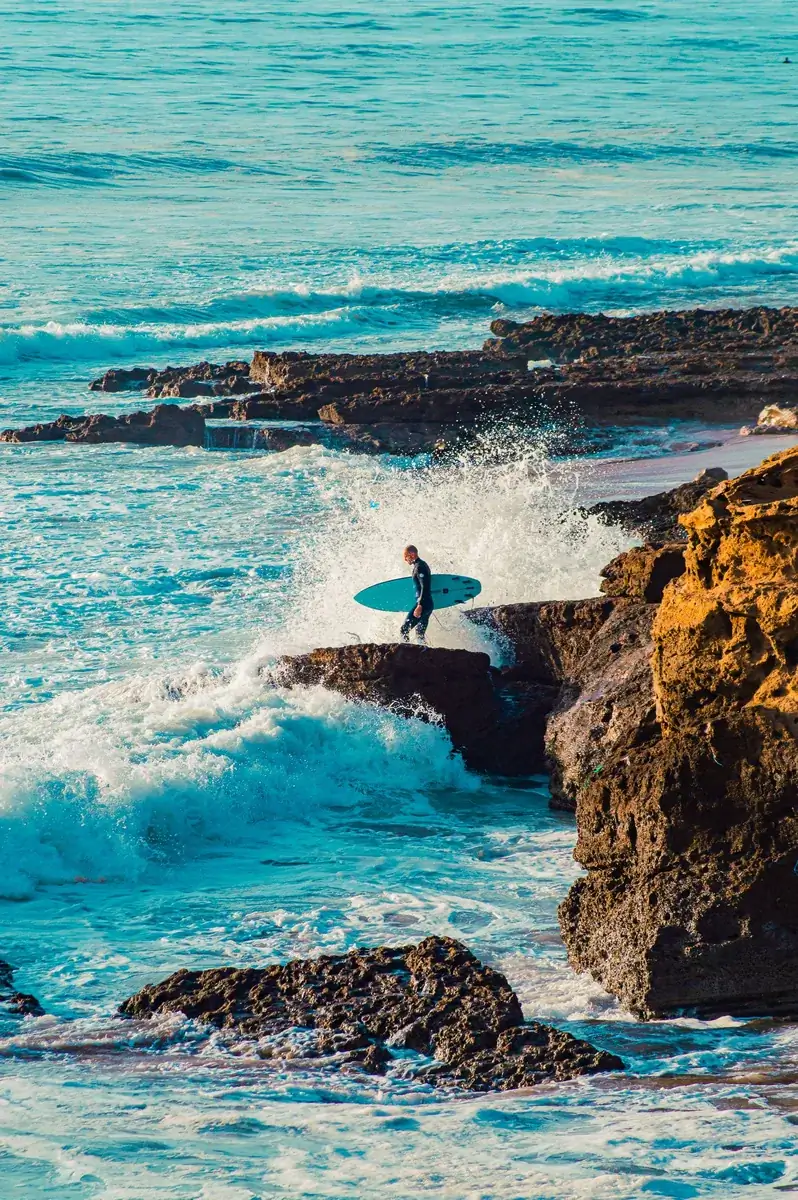 Surfer entering the waves along the Taghazout coast